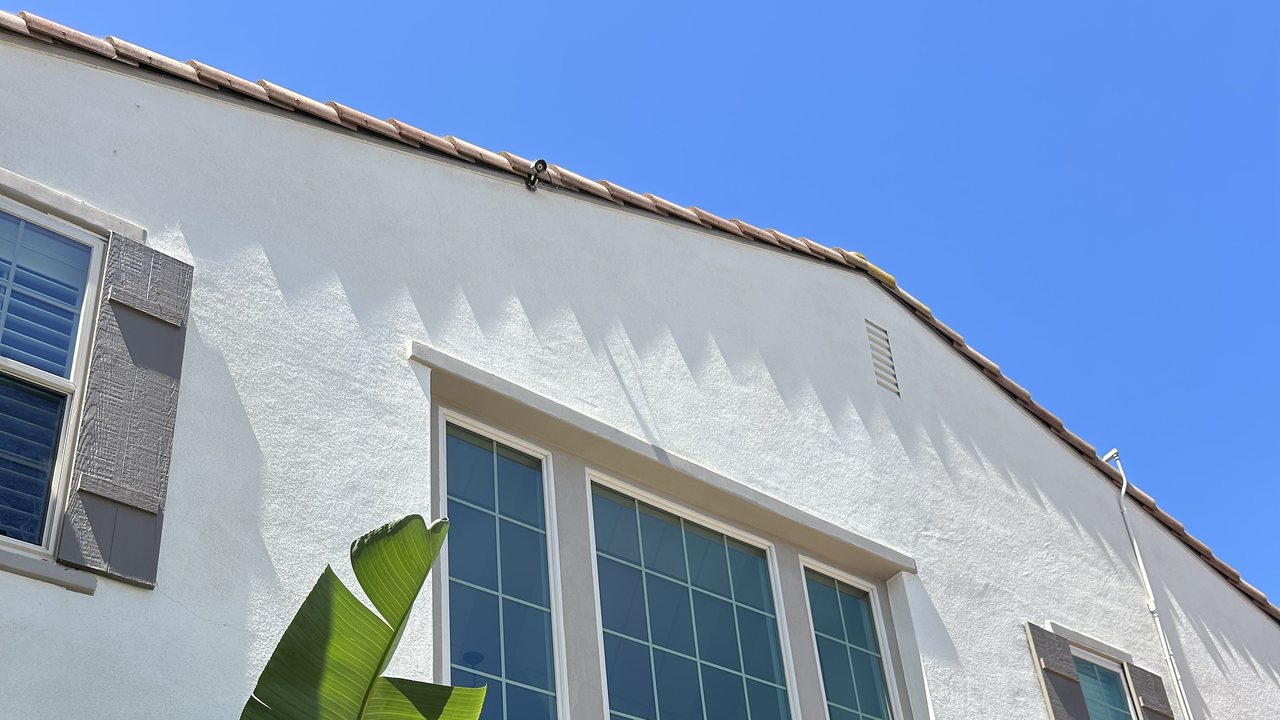 San Diego home with clean windows and a barrel tile roof against a clear blue sky